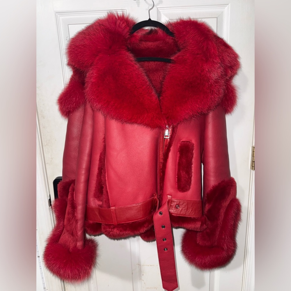 RED SHEARLING JACKET WITH FOX FUR AND HOOD.